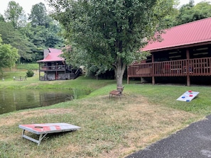Play corn hole by the pond