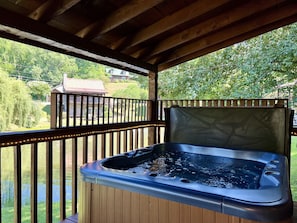 Hot tub with cover lift for easy access and rope lights for night time ambience