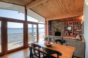 Stone fireplace and warm woodwork throughout .