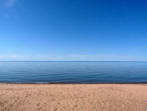 Public sand beach across the highway from the cabin. You can have small fires do