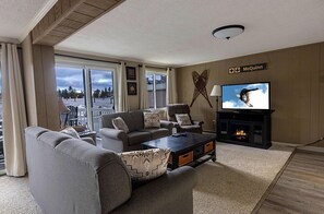 Cozy up to the electric fireplace next to the 51" TV.