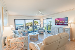 Relax in the oceanfront living room, featuring breathtaking views and a large smart TV