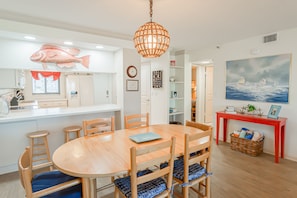 The dining room offers seating for six at the table, plus additional seating with barstools