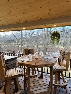 Outside covered deck overlooks the stream-road-and ski slope only minutes away