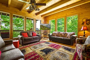 Spacious living room includes a sleeper sofa.