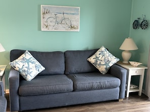 Sofa with pull out double bed in living area.