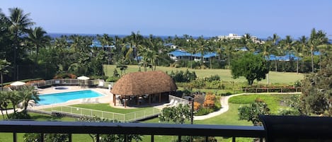 View of pool, fairway of Kona Country Club and ocean from lanai