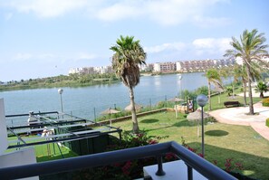 view from balcony overlooking gardens, pool and lake