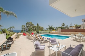 Garden with barbecue, seating area, dining area, shower, sunloungers and Pool