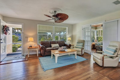 View of living room and front entry.  Comfortable couch and several recliners.