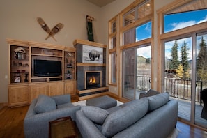 Living room with TV and fireplace