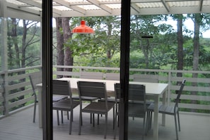 A screened-in porch is perfect for outdoor dining and relaxation.