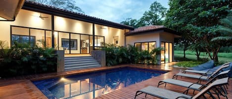 Private pool and sun bed decking, with view to the outdoor patio