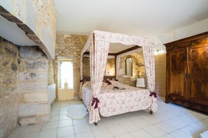 The main bedroom with four poster bed.