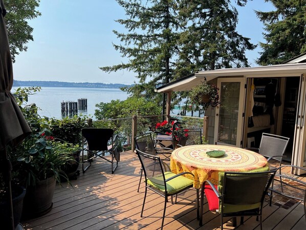 Dining deck off kitchen awash with flowers in season