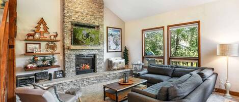 Step down into the living room with plush seating, gas fireplace and flat screen TV.