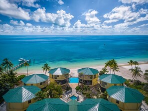 Aerial view looking out on the pool and beachfront on a typical tropical day