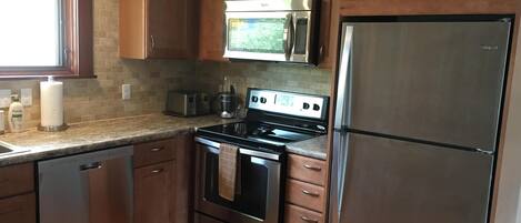 newly emodeled kitchen with toaster, coffee maker, etc.