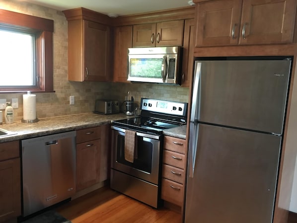 newly emodeled kitchen with toaster, coffee maker, etc.