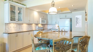 Remodeled kitchen with granite counter tops and marble backsplash