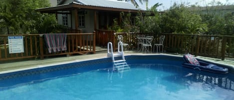 A view of the Pool House from the other side of the pool.