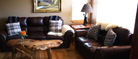 Enjoy the comfy leather couches, soft warm throws and organic coffee table.