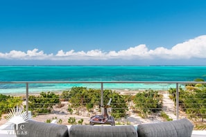 Sandpebble's master suite offers a balcony overlooking Grace Bay Beach. 