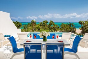 Sandpebble's pool area equipped with outdoor dining table, BBQ grill, and more. 