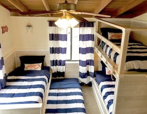 Custom built-in twin bunkbeds designed to sleep adults or kids. Toys, books