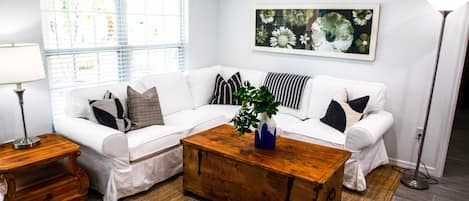 Beautiful living room with comfy furniture & tons of natural light.