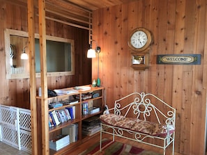 Entryway seating.  Baby proof gate to the side leading to the downstairs.