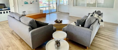 Upstairs living area with balcony and view to beach