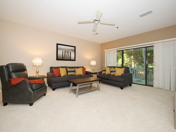 Ocean Breeze 100 - Living Area - Located off the living area is a nice sized deck with electric grill with a quiet and private wooded view.