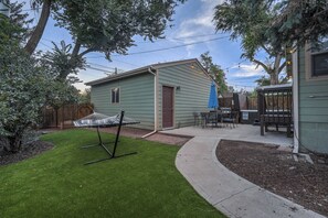 Private backyard with a hammock, hot tub, grill, table and chairs!