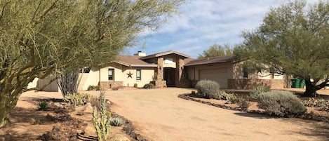 Drive up to the house lined with cactus gardens, palo verde trees and Sajuaros