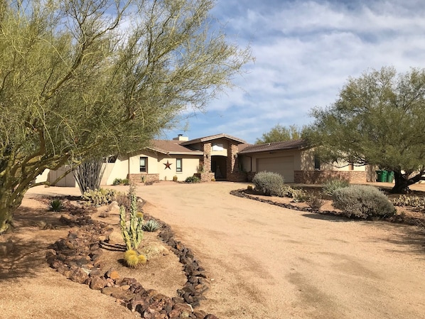Drive up to the house lined with cactus gardens, palo verde trees and Sajuaros