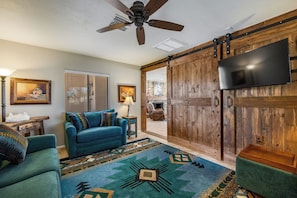 den/4th bedroom with full wall barn doors that close off for privacy-