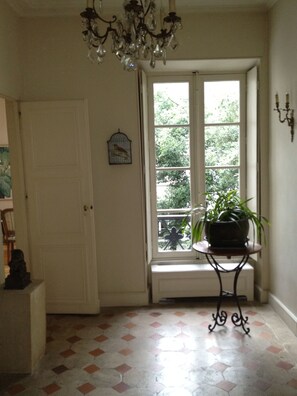 Foyer: Window looks out over private garden. Kitchen door to left.