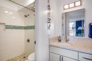 Fully remodeled Bathroom with Walk-in shower and well lit pedestal basin.