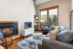 Inviting living room with gas fireplace and views of the golf course.