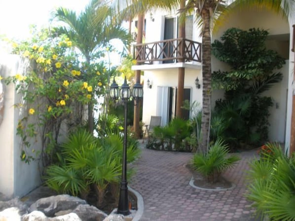 Street-side entry with garden and secure gates, 24 hour security