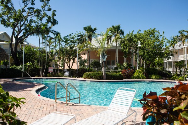 Huge pool (heated in winter) with clubhouse in background that has bathrms, deck