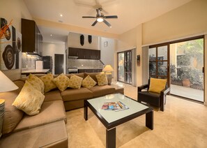 TV lounge and kitchen area with view of court yard 