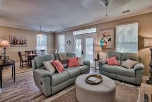 Spacious living space featuring a cozy reclining sofa, ideal for relaxation.