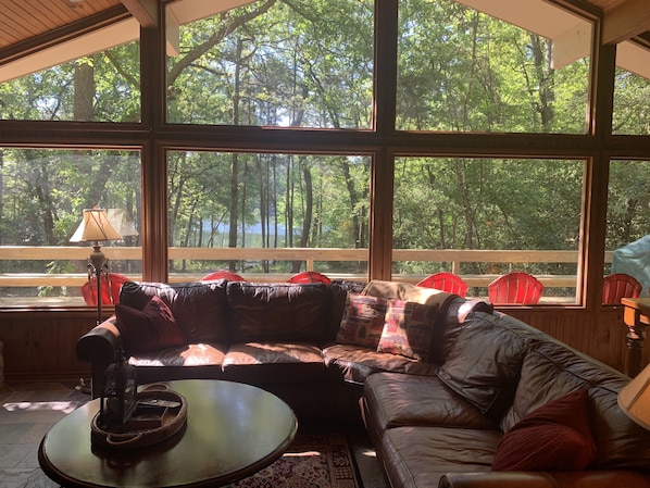 Wall of windows with beautiful view of Whispering Winds Lake.