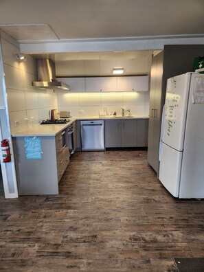 New kitchen with gas cooktop, electric oven, dishwasher, fridge, gas hot water. 