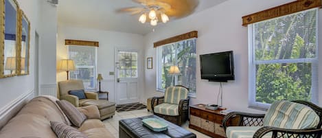 Spacious living area with three comfy chairs and sleeper sofa.