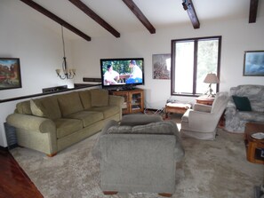 Spacious living room with 55 inch flat screen..