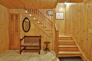 The foyer with coat closet and steps to the main level.