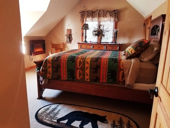 upstairs bedroom 3 with electric fireplace and window seat.